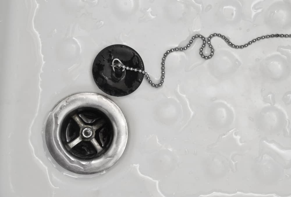 how to block a bathtub drain without a plug